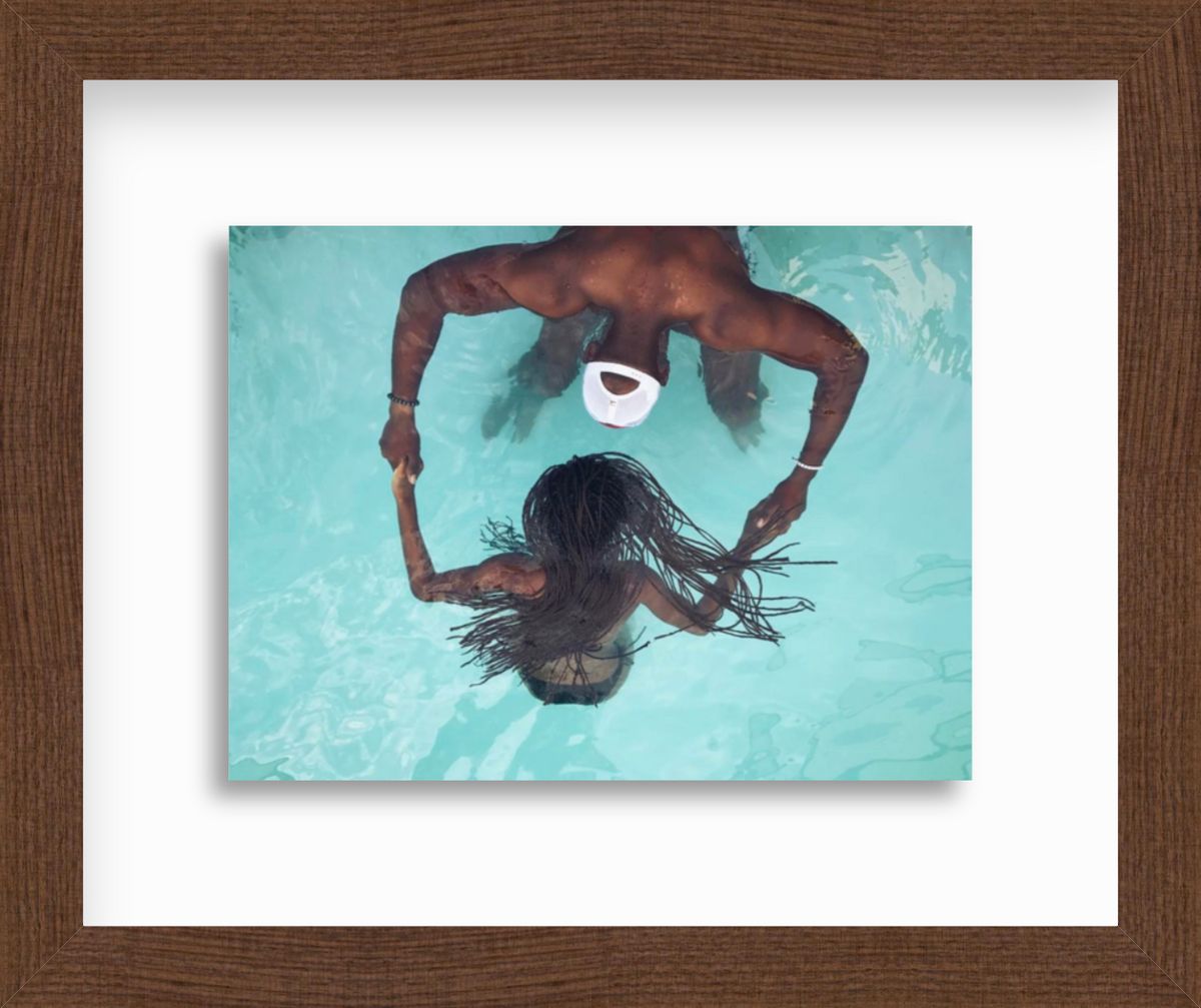 Man and woman in pool in frame
