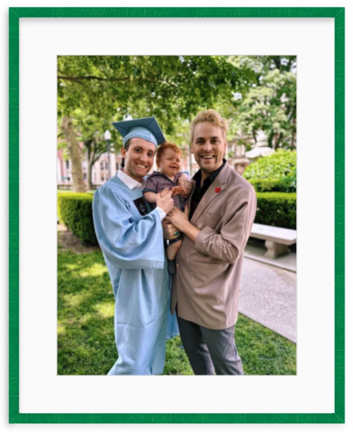 Graduation photo with dads and son