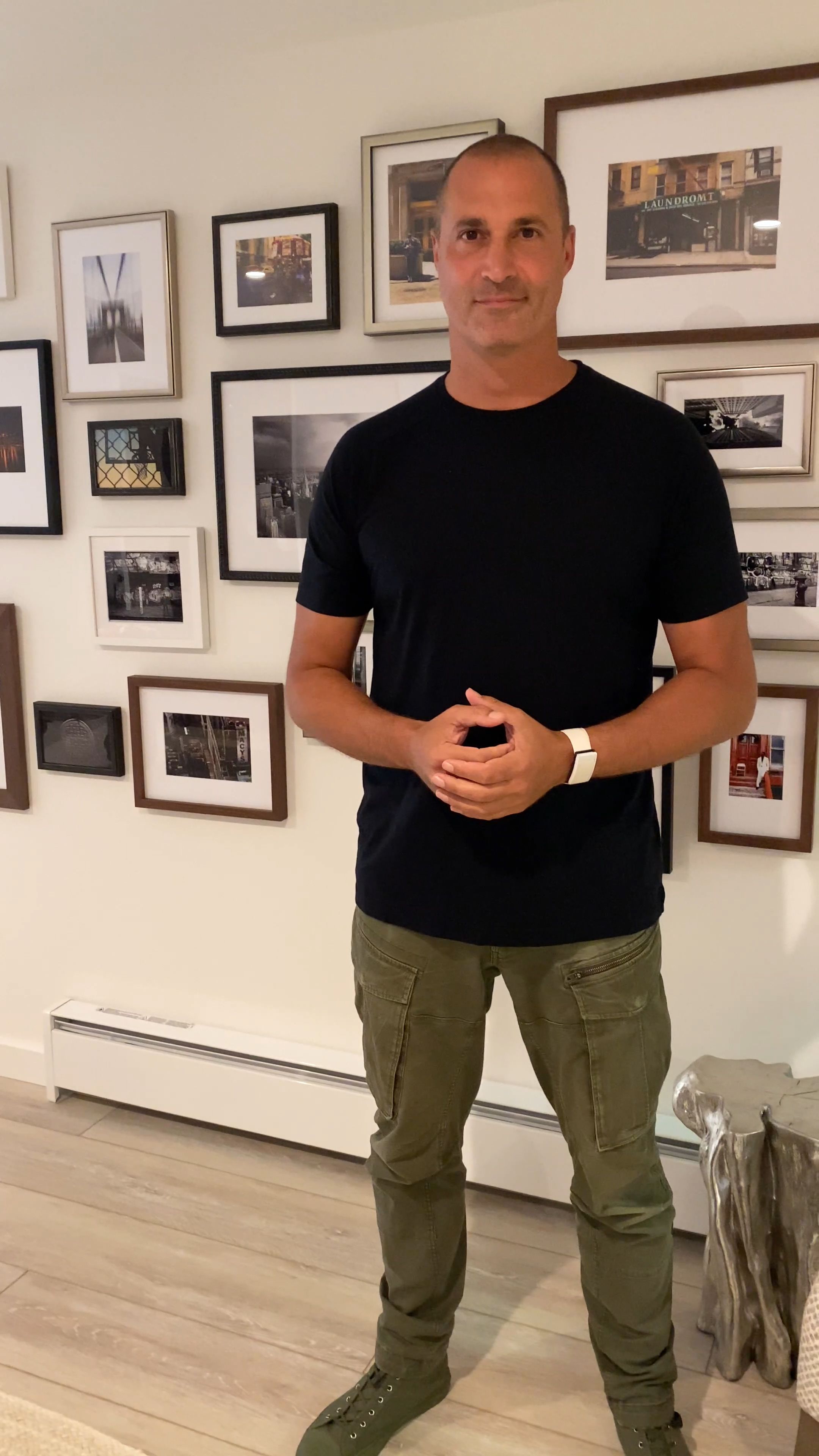 Nigel Barker in front of gallery wall