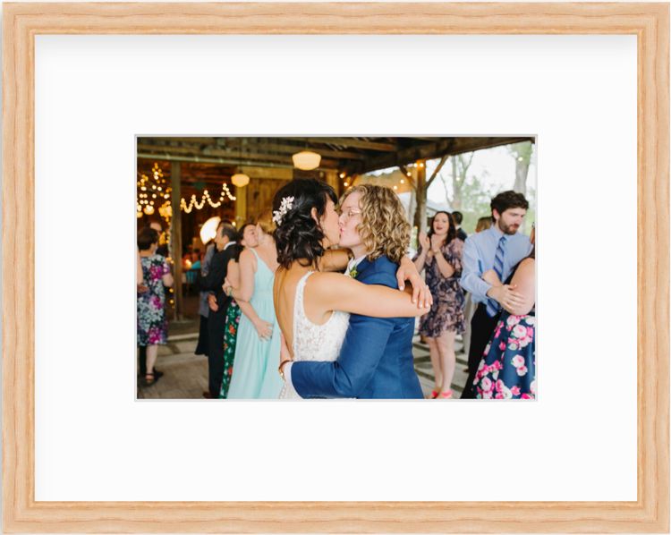 Couple kissing at wedding in a wood frame