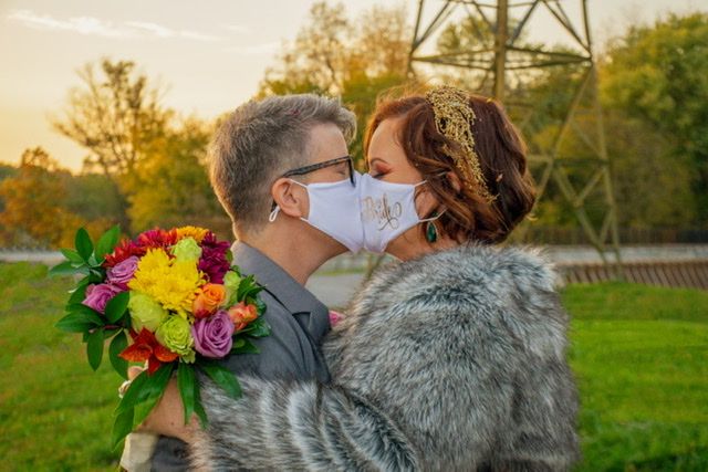 couple kissing with masks on